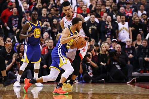 Steph Curry #30 of the Golden State Warriors is defended by Danny Green