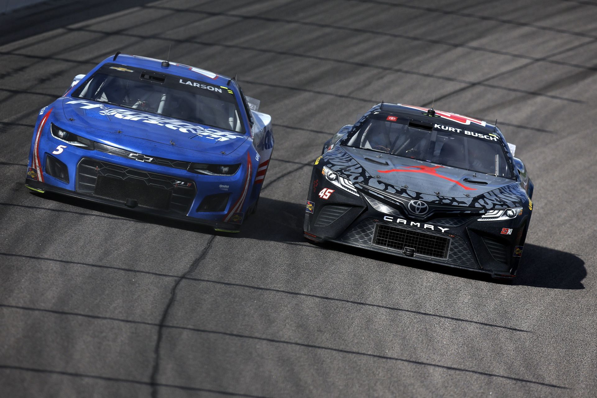 Kyle Larson (left) and Kurt Busch (right) race during the NASCAR Cup Series AdventHealth 400 at Kansas Speedway (Photo by Sean Gardner/Getty Images)