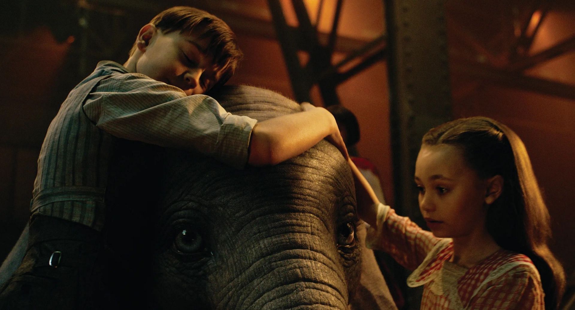 The children comforting the baby elephant (Image via Disney)