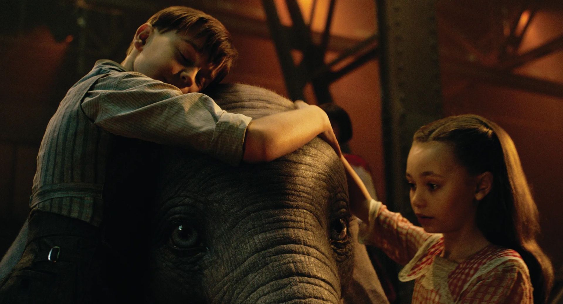 The children comforting the baby elephant (Image via Disney)