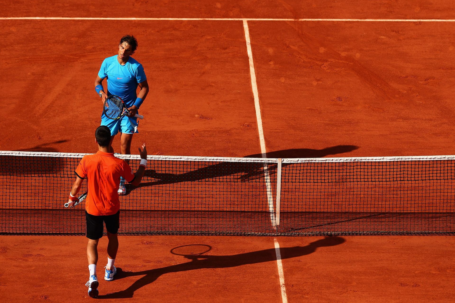 Rafael Nadal (in blue) has had nine meetings with Novak Djokovic at Roland Garros