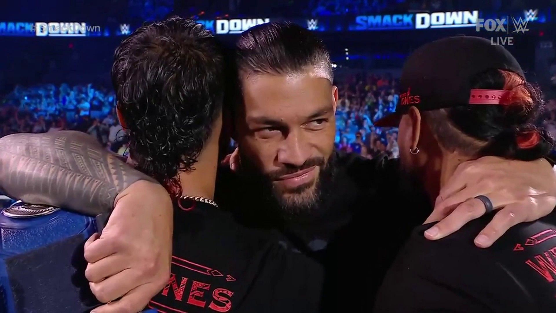 Roman Reigns embracing The Usos on SmackDown