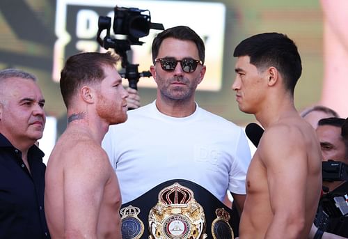 Canelo Alvarez (L) and WBA Light Heavyweight Champion Dmitry Bivol (R) face off as Matchroom Sport Chairman Eddie Hearn (C) looks on