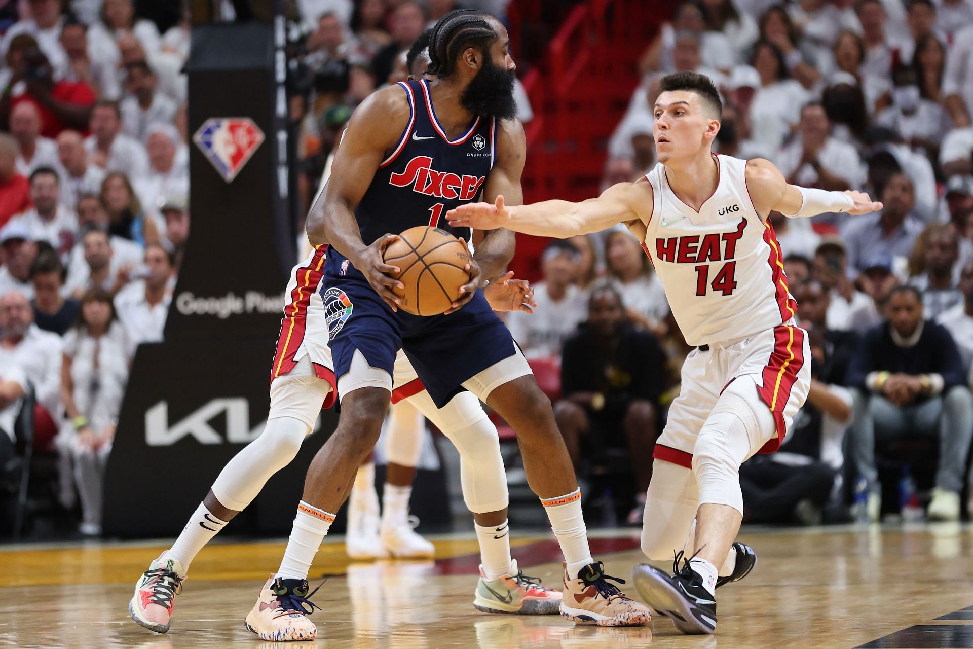 Tyler Herro of the Miami Heat attempts to steal the ball from James Harden of the Philadelphia 76ers.