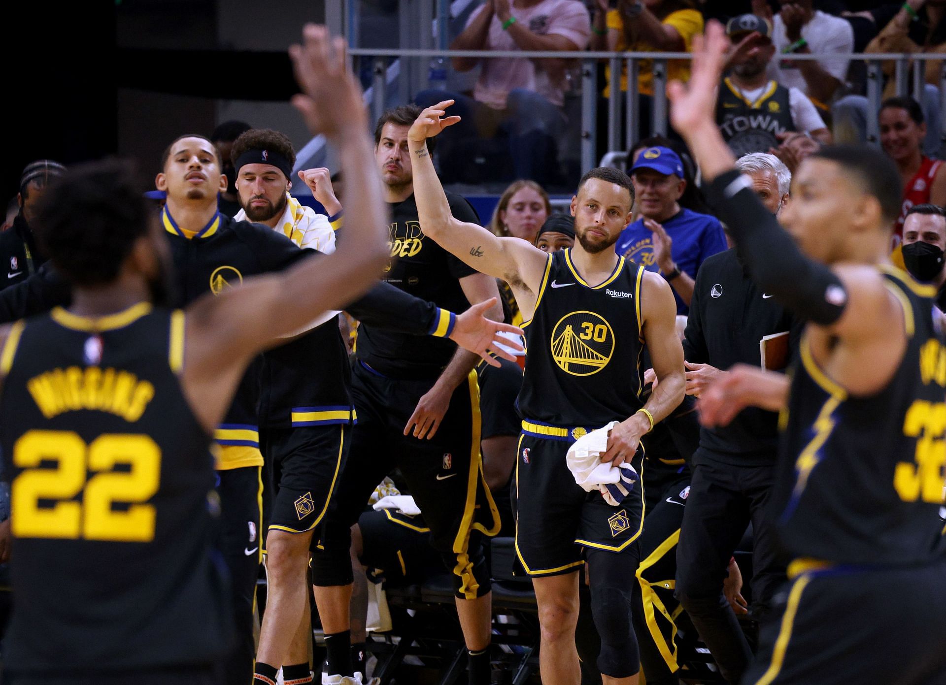 Steph Curry celebrates a lead from the Golden State Warriors' bench