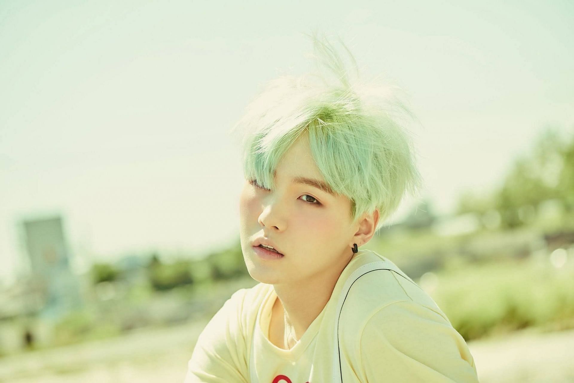 K-pop idols have often aced the mint green hairstyle, including BTS&#039; SUGA (Image via Agatha/Pinterest)