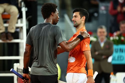 Djokovic shakes hands at the net after his straight-sets victory against Gael Monfils in the second round in Madrid