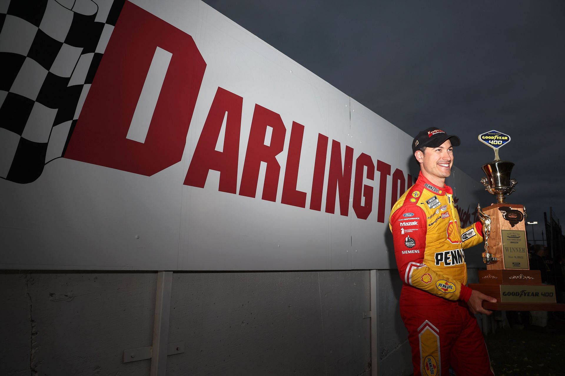 Joey Logano poses with the Goodyear 400 trophy after winning the NASCAR Cup Series Goodyear 400 at Darlington Raceway (Photo by James Gilbert/Getty Images)