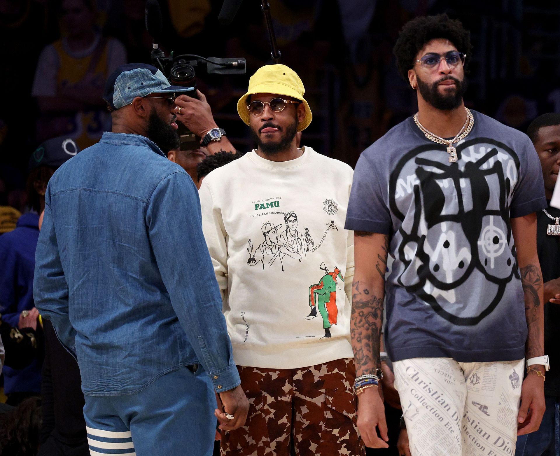 (L-R) LeBron James, Carmelo Anthony, and Anthony Davis of the LA Lakers standing courtside