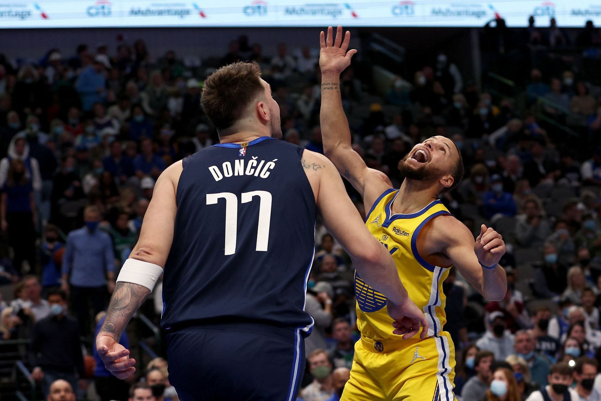 Luka Doncic of the Dallas Mavericks battles Steph Curry of the Golden State Warriors
