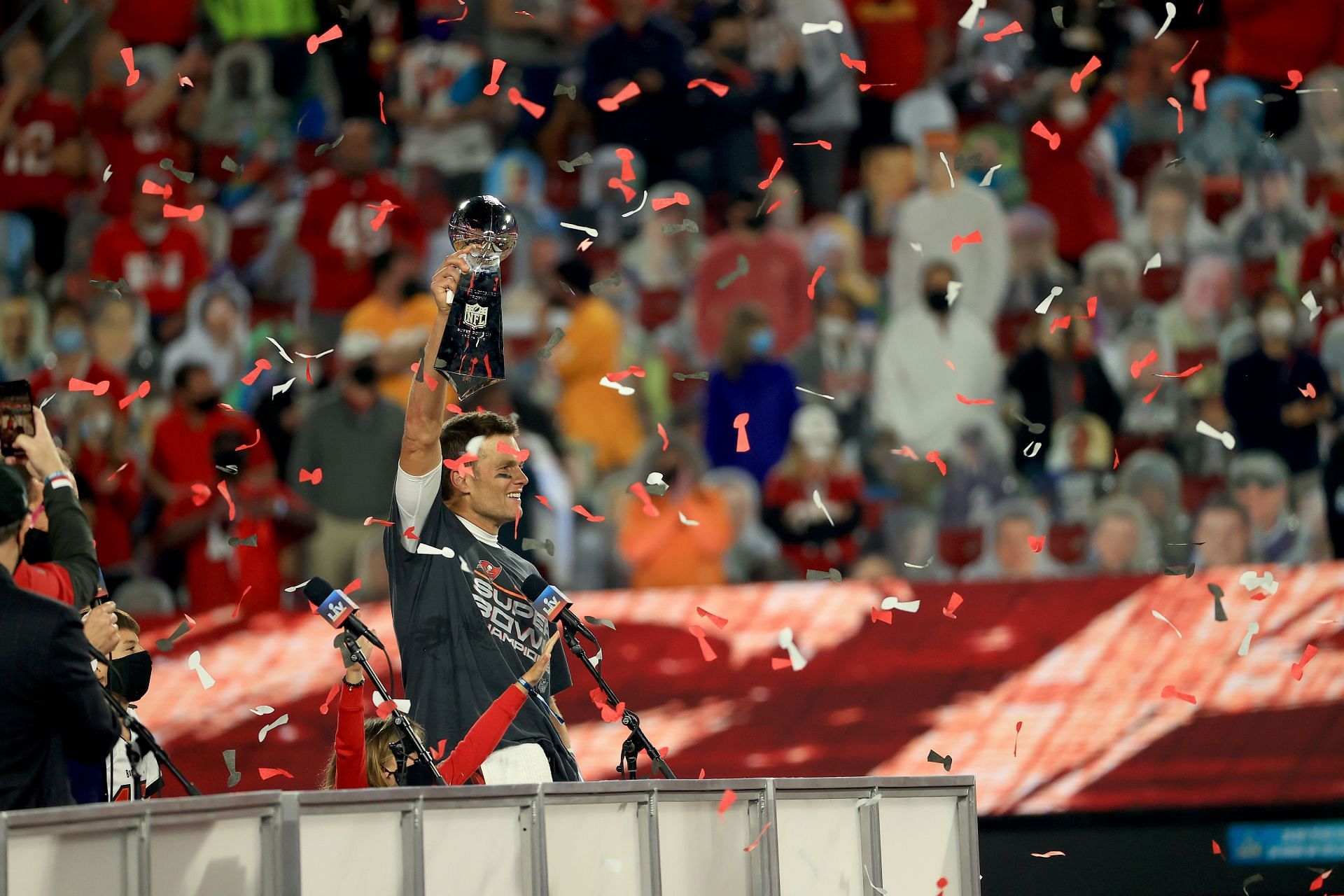 Tom Brady hoisting aloft the Lombardi trophy at Super Bowl LV