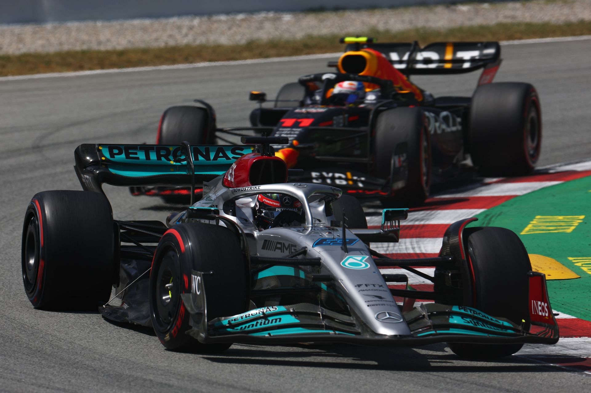 Mercedes driver George Russell (foreground) and Red Bull driver Sergio Perez (background) in action during the 2022 F1 Spanish GP (Photo by Lars Baron/Getty Images)