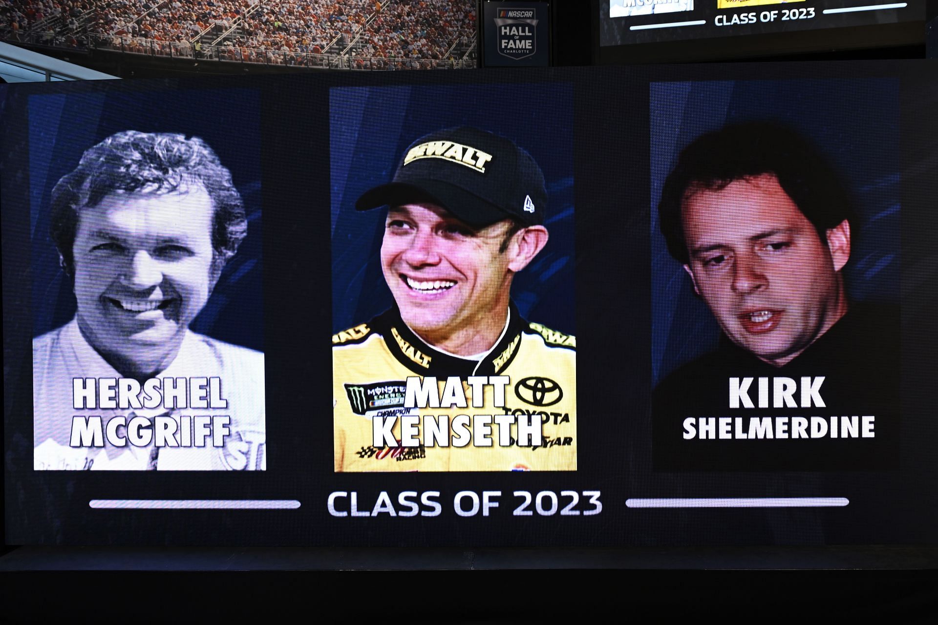 The class of Hershel McGriff, Matt Kenseth, and Kirk Shelmerdine seen on a sign during the NASCAR 2023 Hall of Fame announcement ceremony at NASCAR Hall of Fame in Charlotte, North Carolina. (Photo by Eakin Howard/Getty Images)