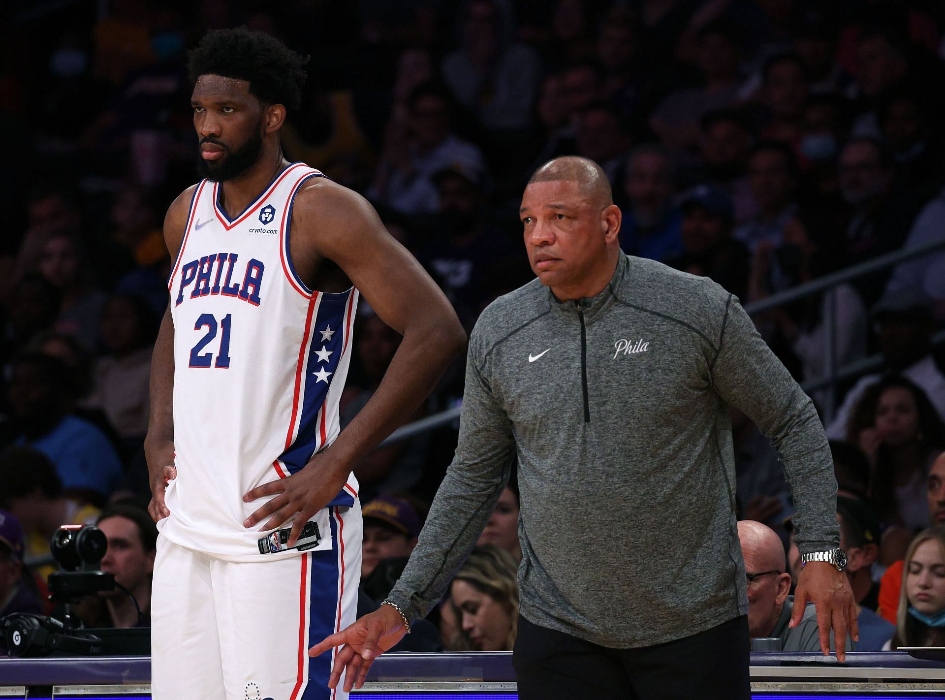 Joel Embiid and Doc Rivers watch from the sidelines during the first half against the LA Lakers on March 23 in Los Angeles, California.