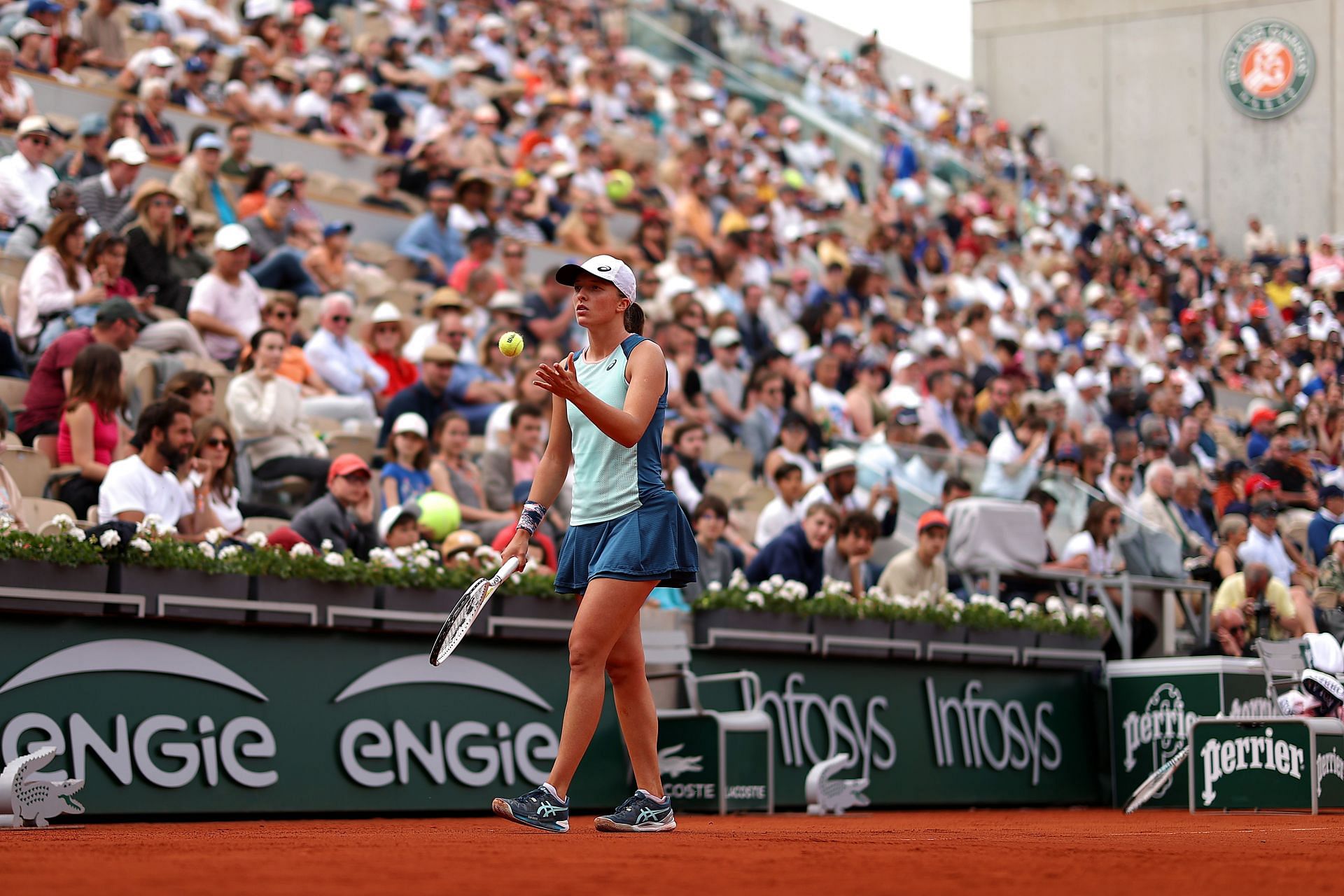 Iga Swiatek gears up for a serve in her fourth-round clash