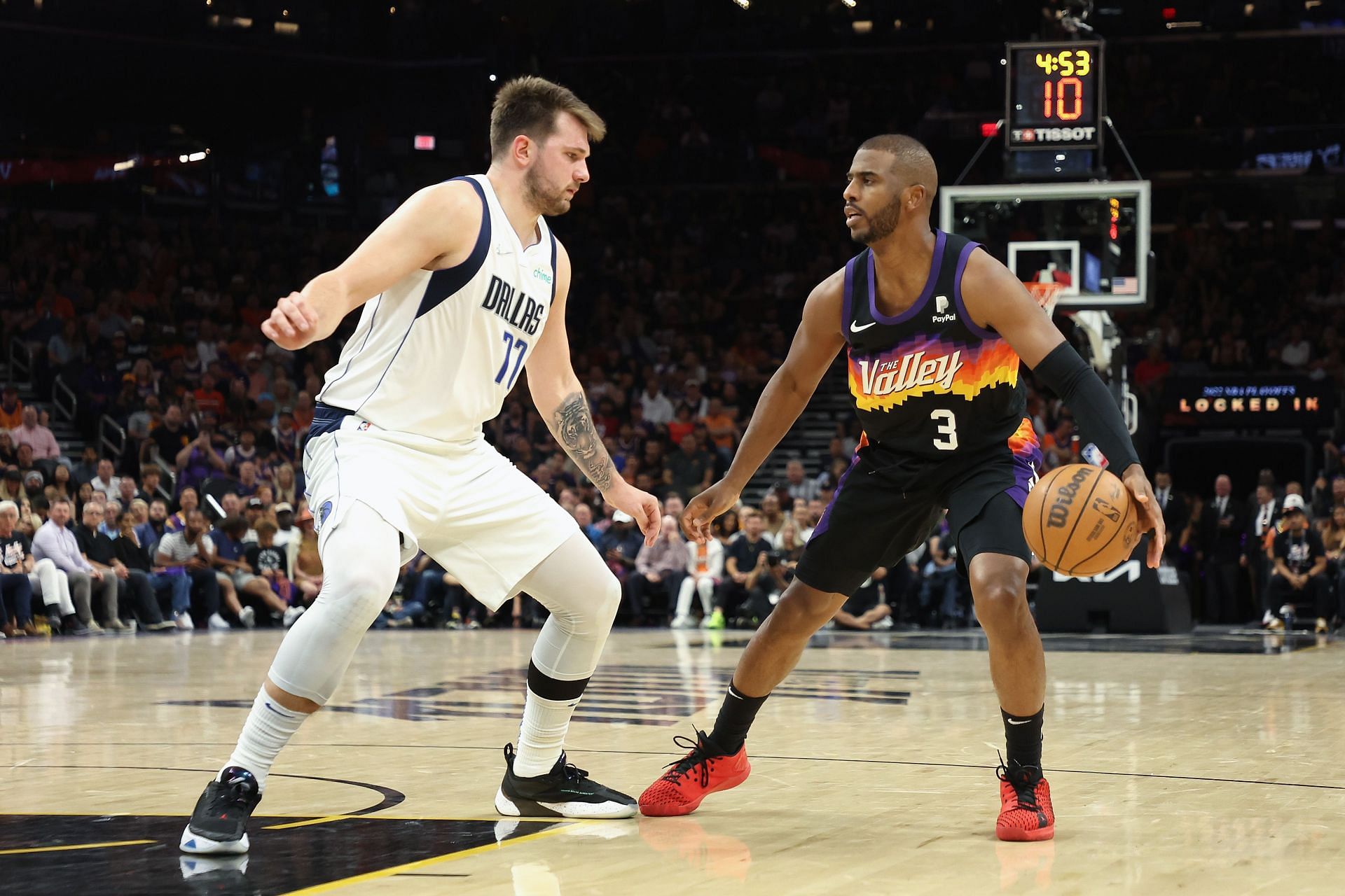 Chris Paul #3 of the Phoenix Suns handles the ball against Luka Doncic #77 of the Dallas Mavericks