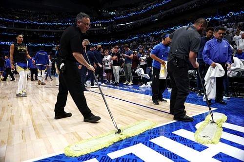 Arena staff clear out the water from the roof leak in Game 4