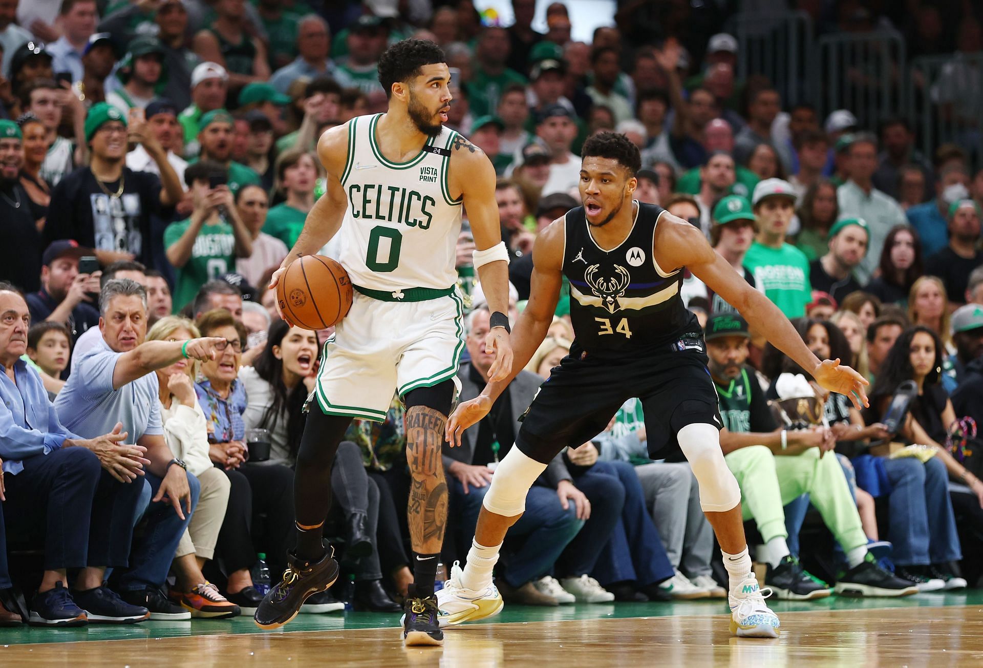 Jayson Tatum attempts to break free of Giannis Antetokounmpo