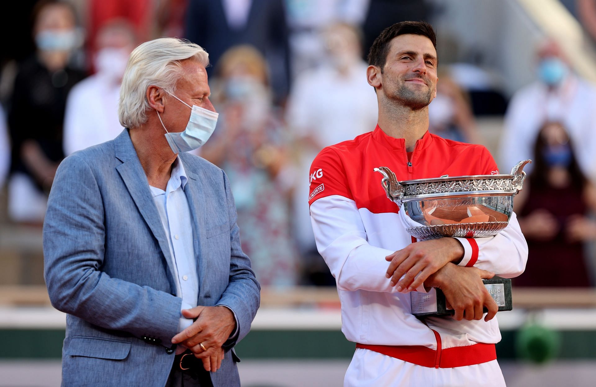 Djokovic with the 2021 French Open trophy next to Bjorn Borg