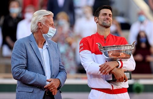 Djokovic with the 2021 French Open trophy next to Bjorn Borg