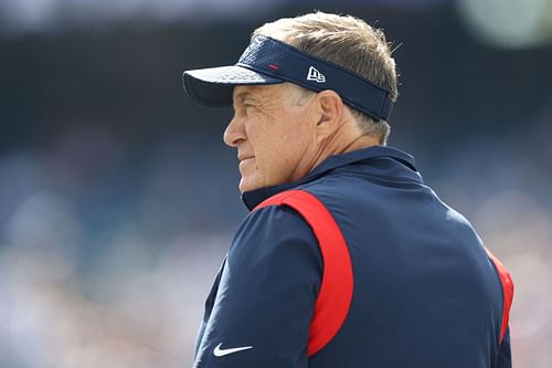 New England Patriots HC & GM Bill Belichick looks on as his players warm up for an NFL game