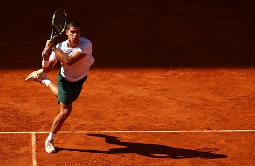 Alcaraz plays a shot during his doubles match with Lopez against Kubot and Roger-Vasselin in Madrid