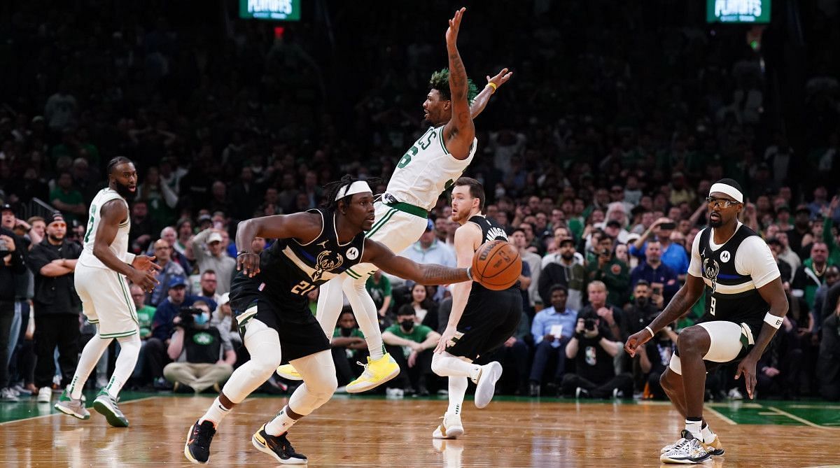 Three seconds after blocking Marcus Smart's shot, Jrue Holiday stripped the ball from Boston's point guard to seal the Bucks' win. [Photo: Sports Illustrated]