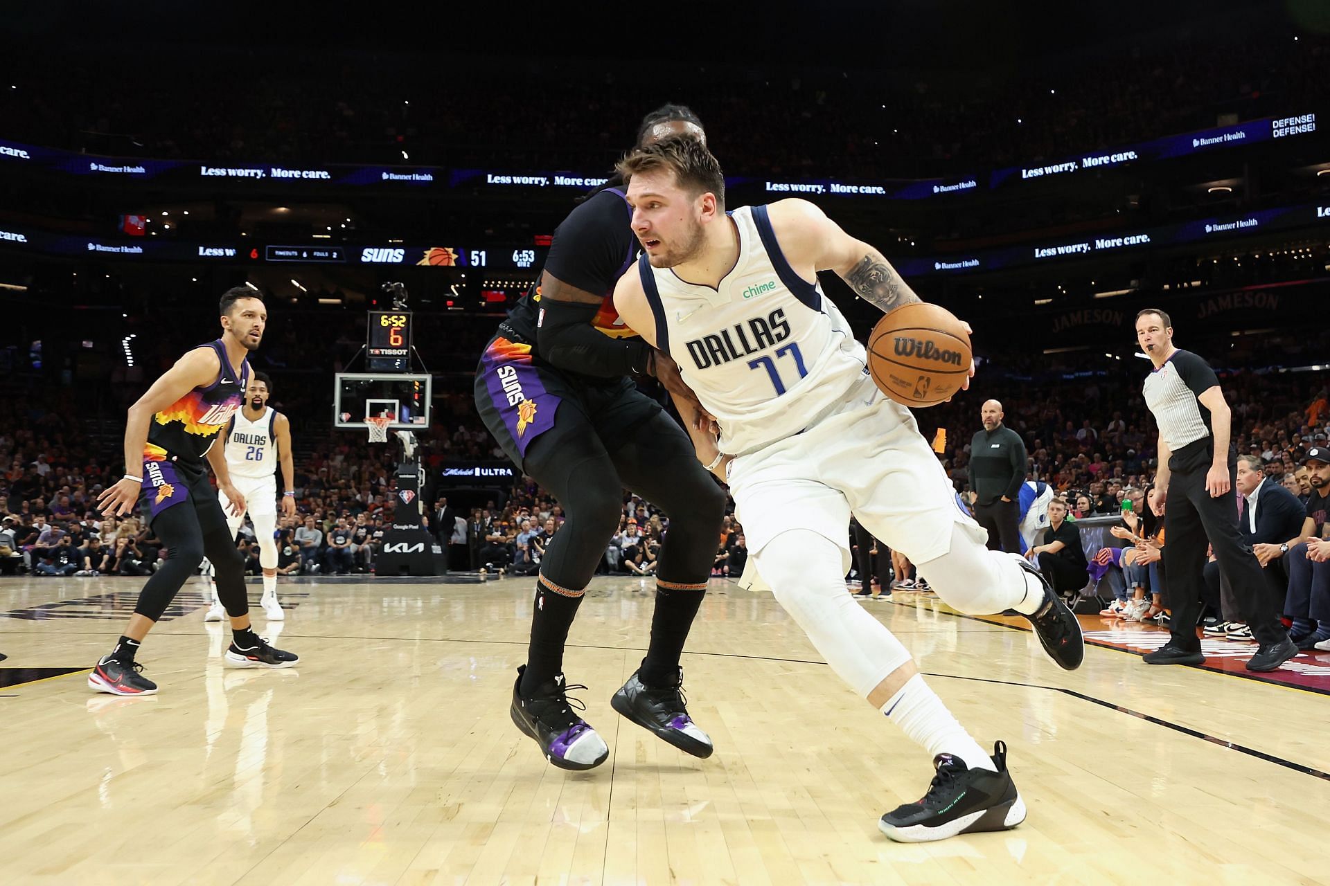 Luka Doncic dribbles past Jae Crowder in Game 1 of the second-round