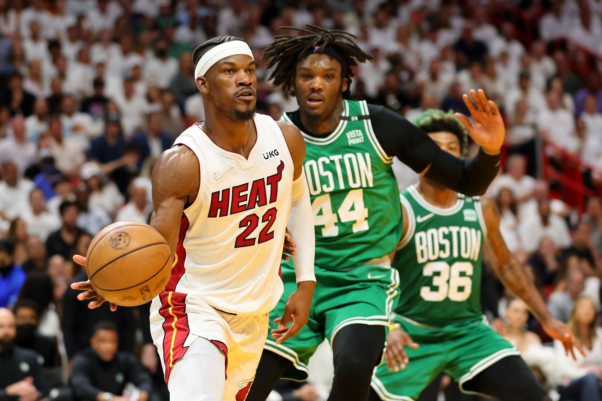Jimmy Butler #22 of the Miami Heat dribbles against Robert Williams III #44 of the Boston Celtics