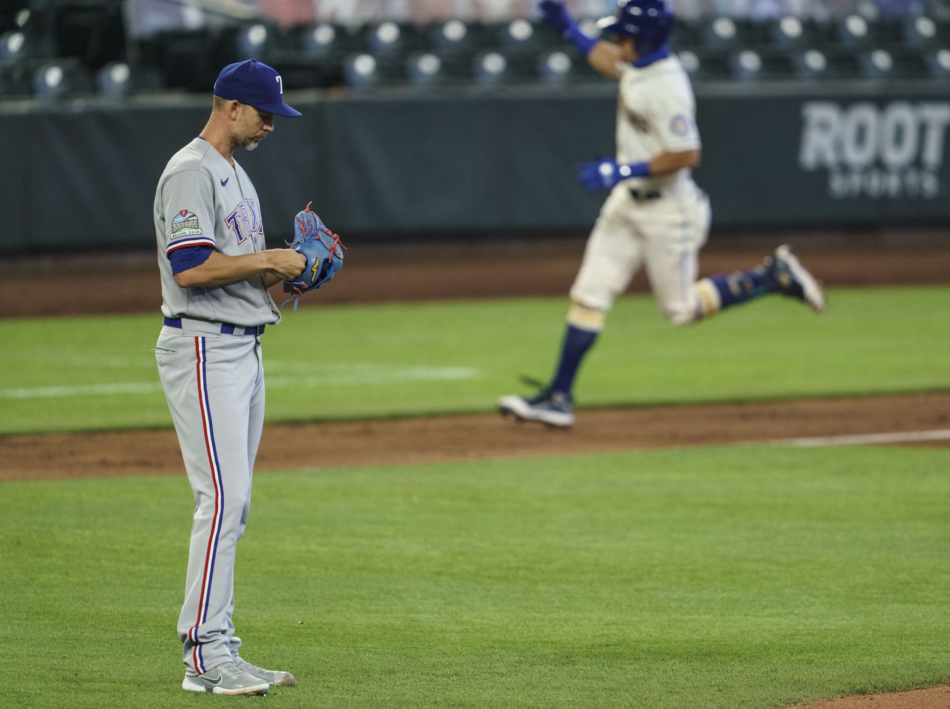 Starting pitcher Mike Minor of the Texas Rangers reacts after giving up a two-run home run.