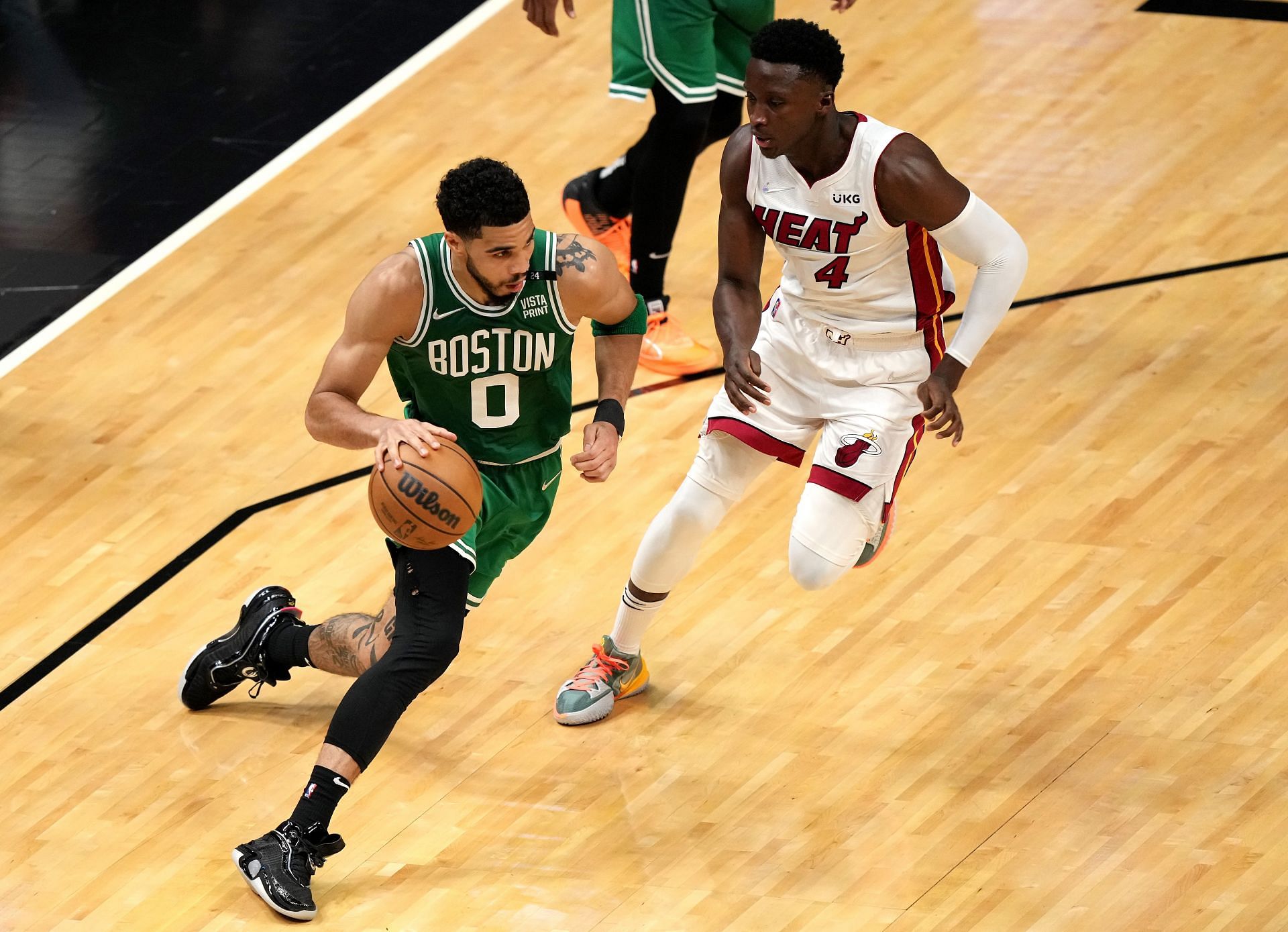 Jayson Tatum of the Boston Celtics drives to the basket against Victor Oladipo of the Miami Heat.