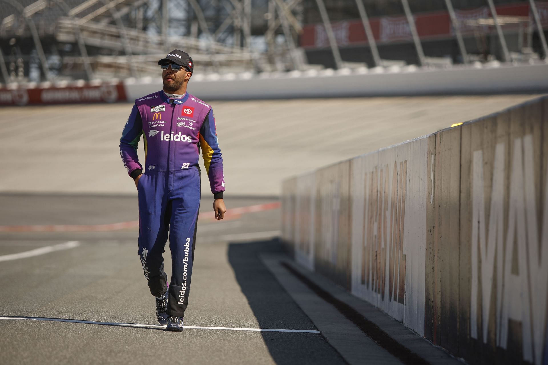 Bubba Wallace Jr. walks the grid during practice for the DuraMAX Drydene 400 presented by RelaDyne at Dover Motor Speedway.