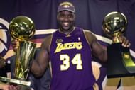 Shaquille O'Neal with the NBA Finals MVP and the Larry O'Brien trophies.