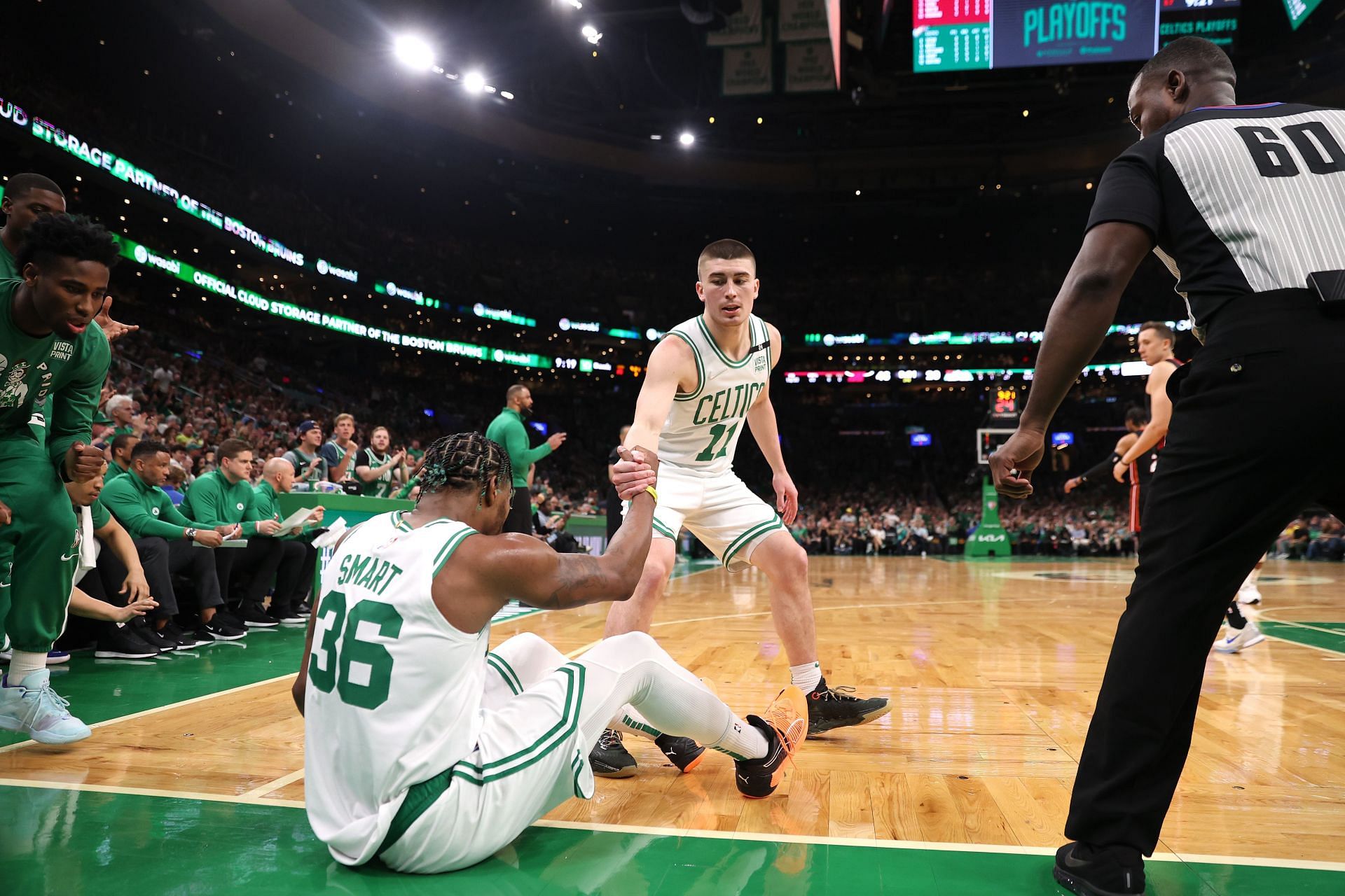 Marcus Smart being helped up by Payton Pritchard