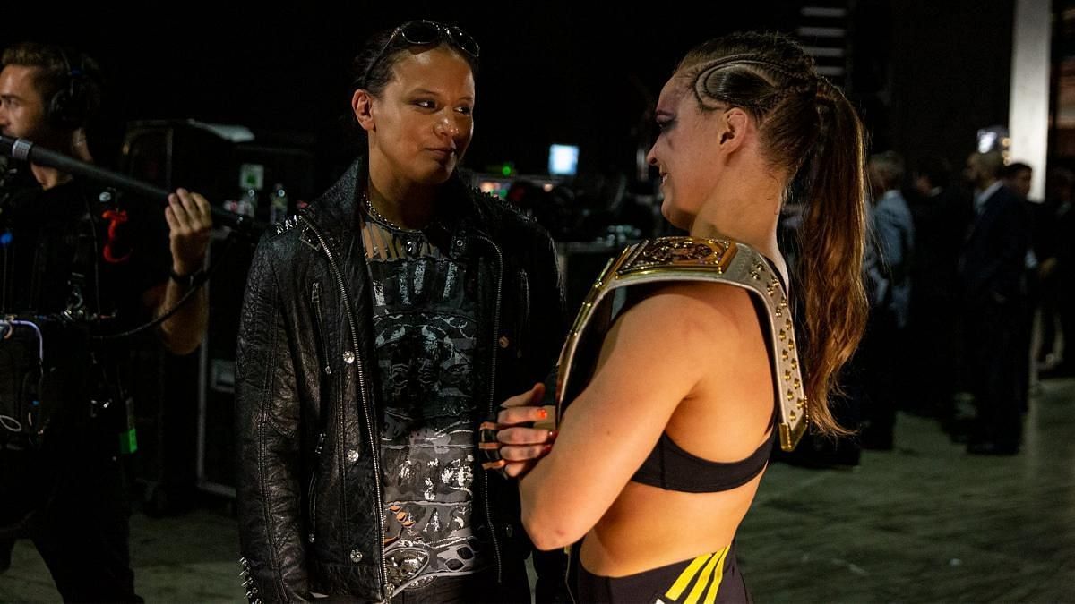 Ronda Rousey talking with Shayna Baszler backstage