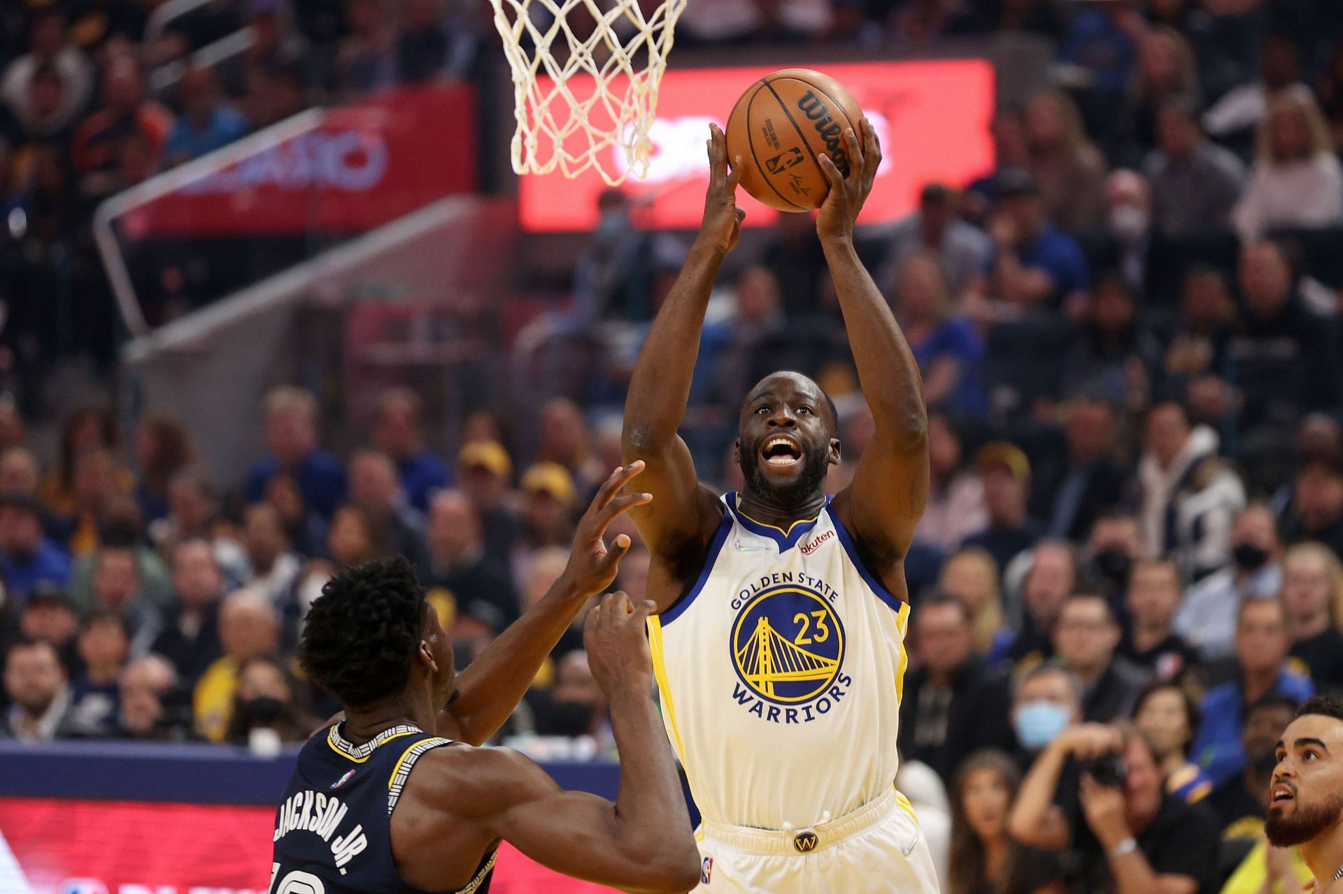 Draymond Green of the Golden State Warriors shoots over Jaren Jackson Jr..