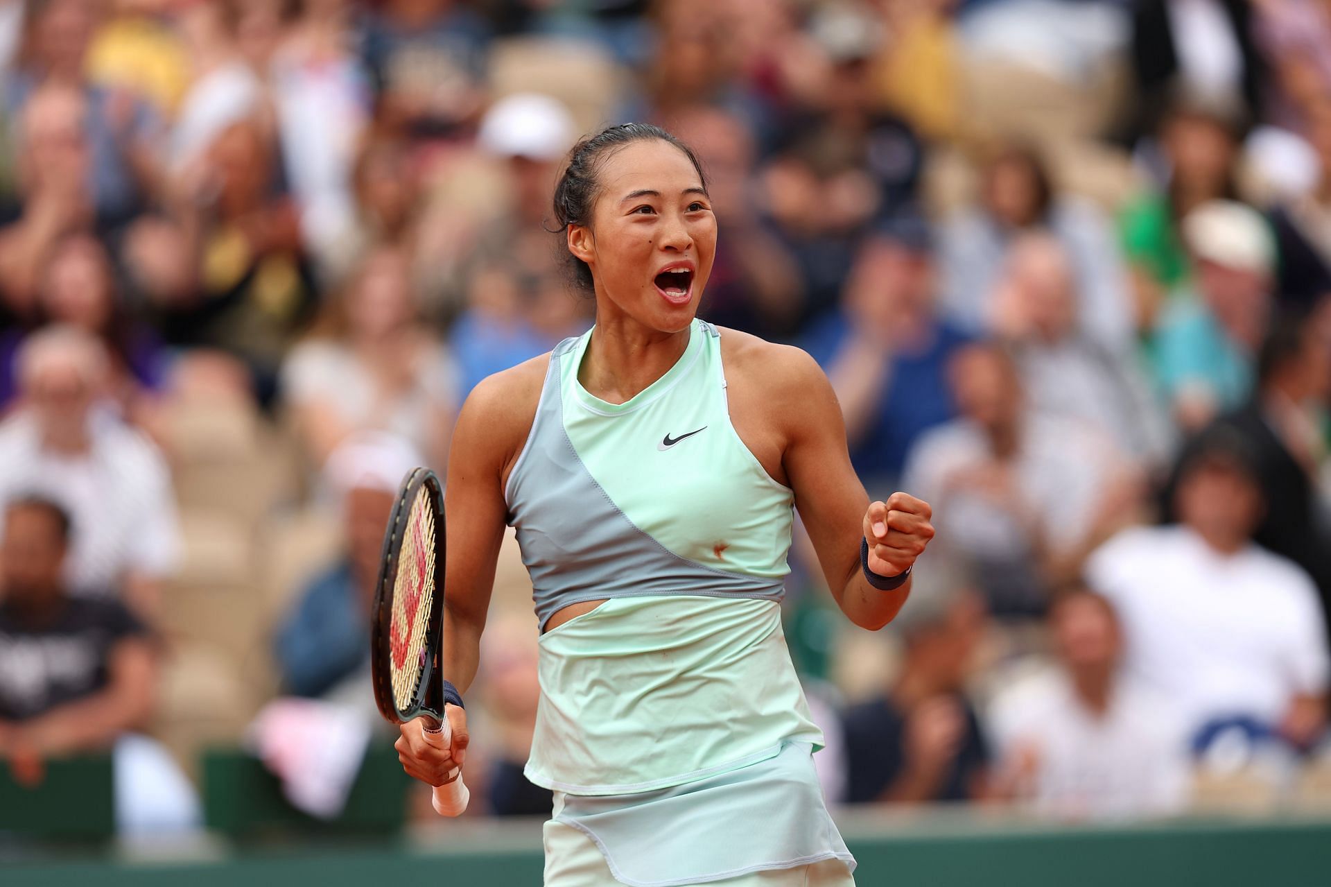 Qinwen Zheng exults after beating Simona Halep at the 2022 French Open - Day Five