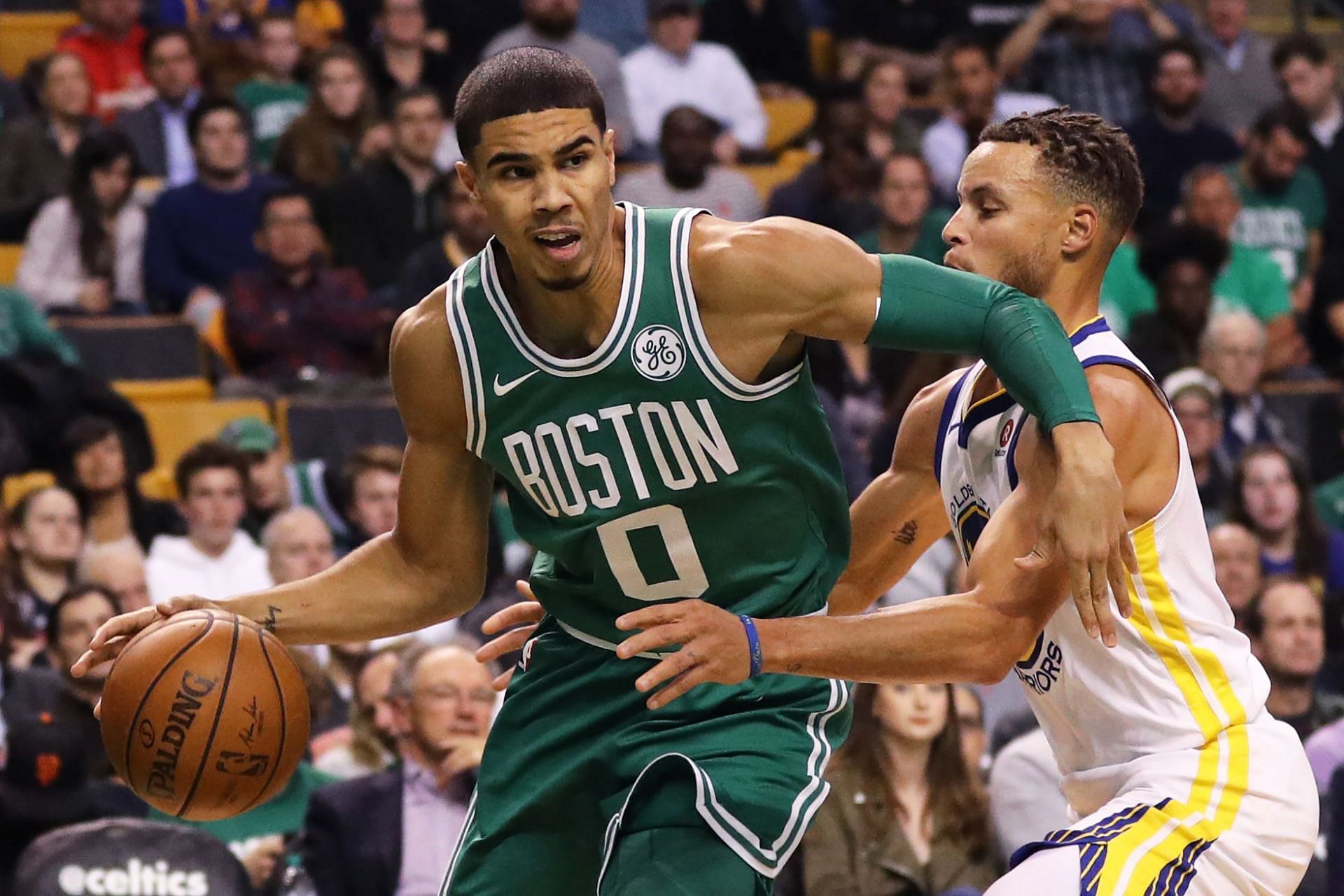 Steph Curry of the Golden State Warriors defends Jayson Tatum of the Boston Celtics in 2017.