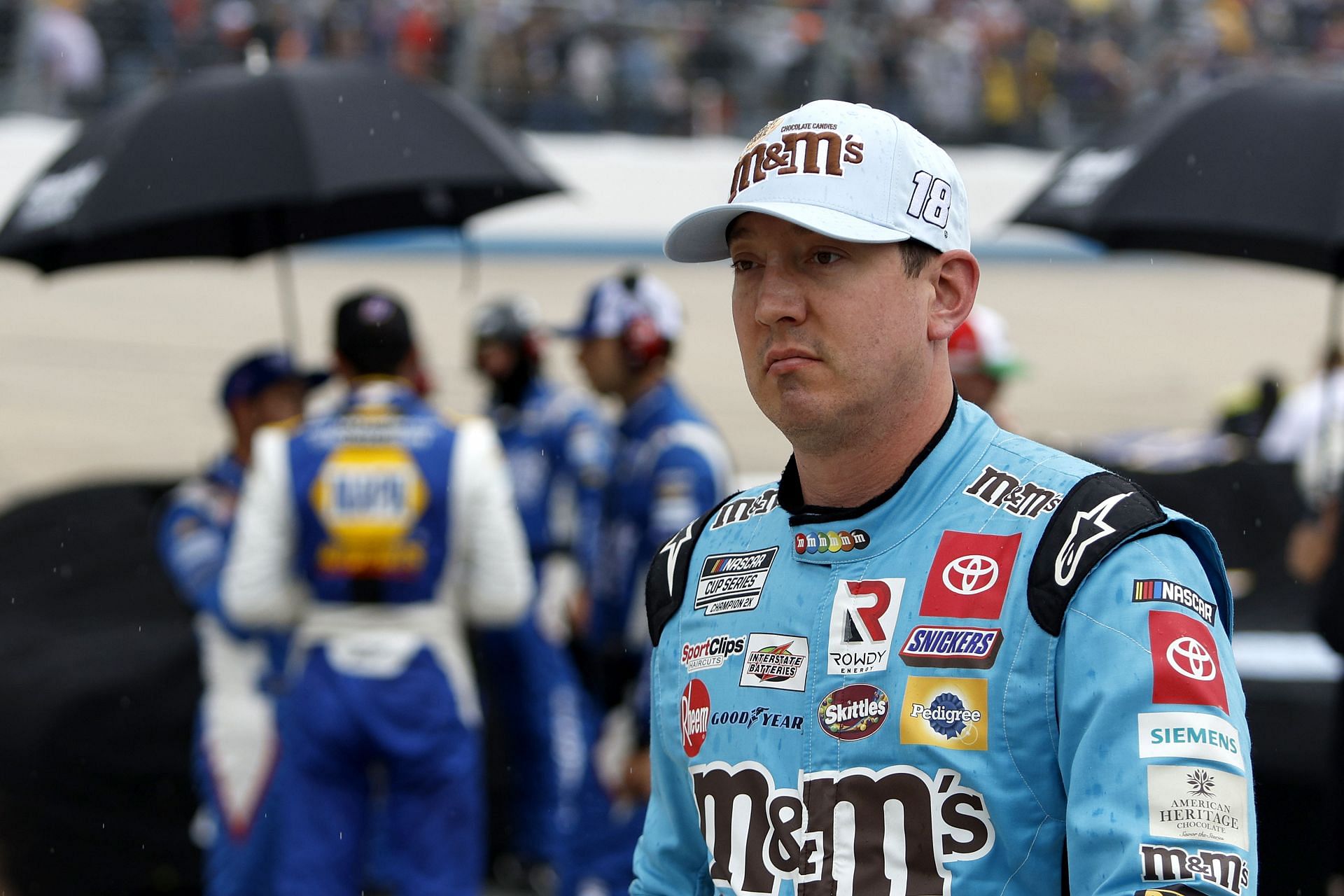 Kyle Busch walks the grid during a rain delay in the NASCAR Cup Series DuraMAX Drydene 400 presented by RelaDyne at Dover Motor Speedway.