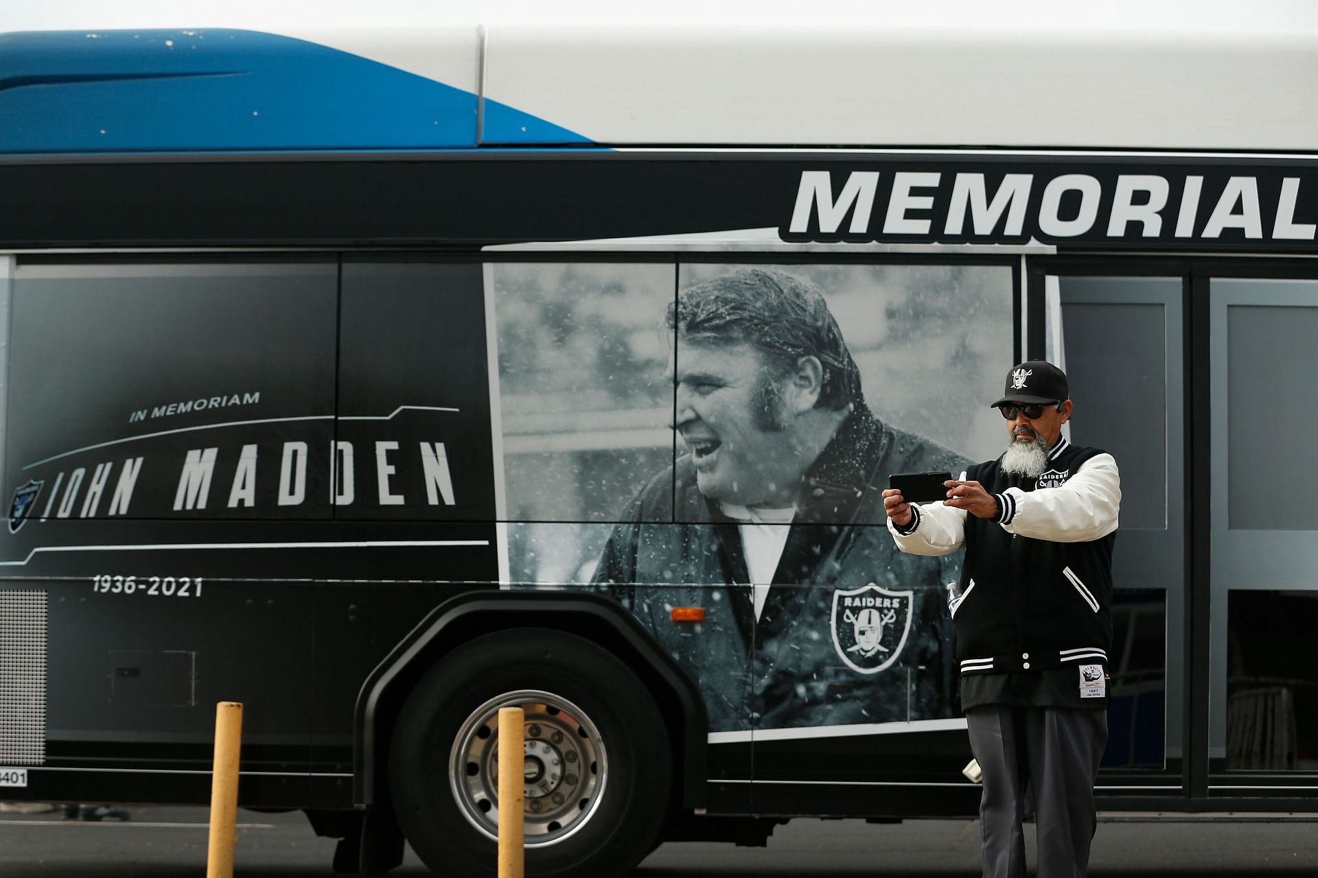 A fan taking a picture at the service held in Oakland for NFL Hall of Fame head coach John Madden