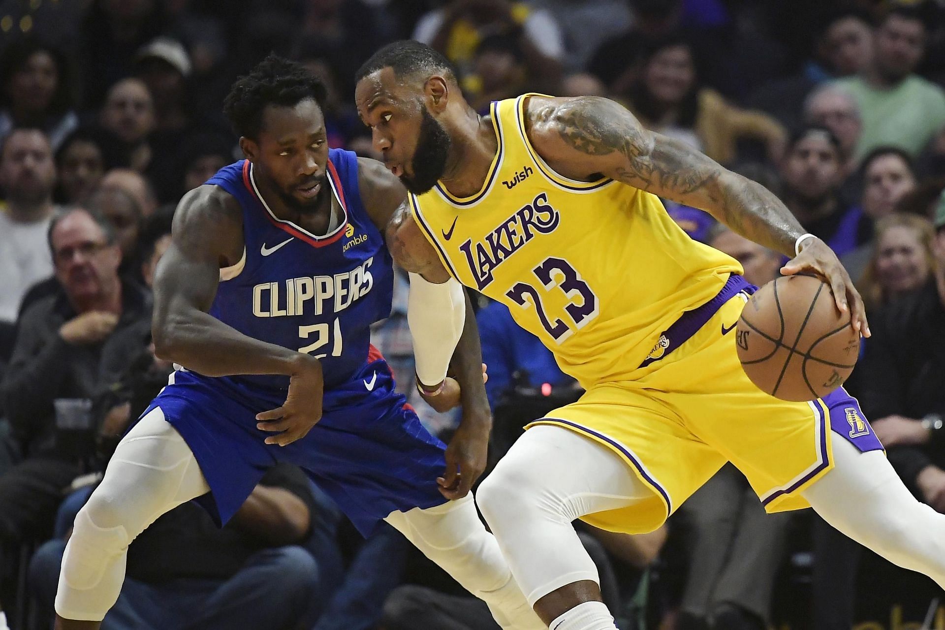 Patrick Beverley and LeBron James in action during LA Lakers versus LA Clippers game. [Source LA Times]
