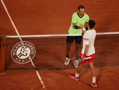 Novak Djokovic and Rafael Nadal shake hands at French Open 2021. Photo by Adam Pretty/Getty Images