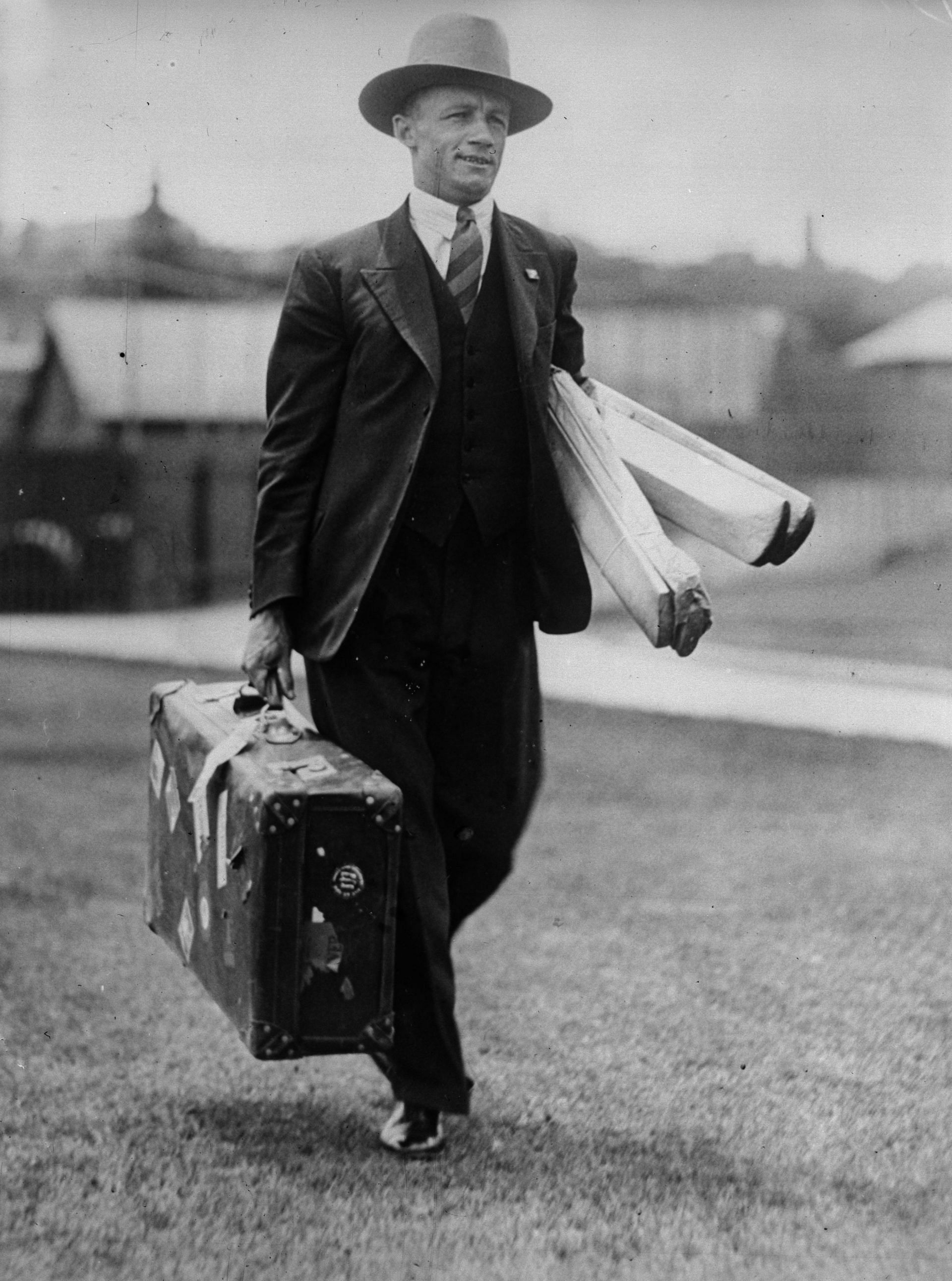 Don Bradman hauls his cricket gear during his momentous tour of England in 1930.