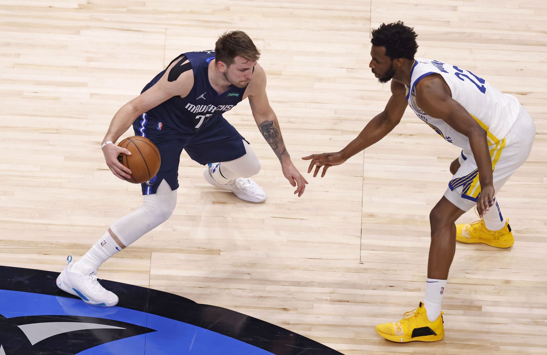 Andrew Wiggins of the Golden State Warriors defends Luka Doncic of the Dallas Mavericks.