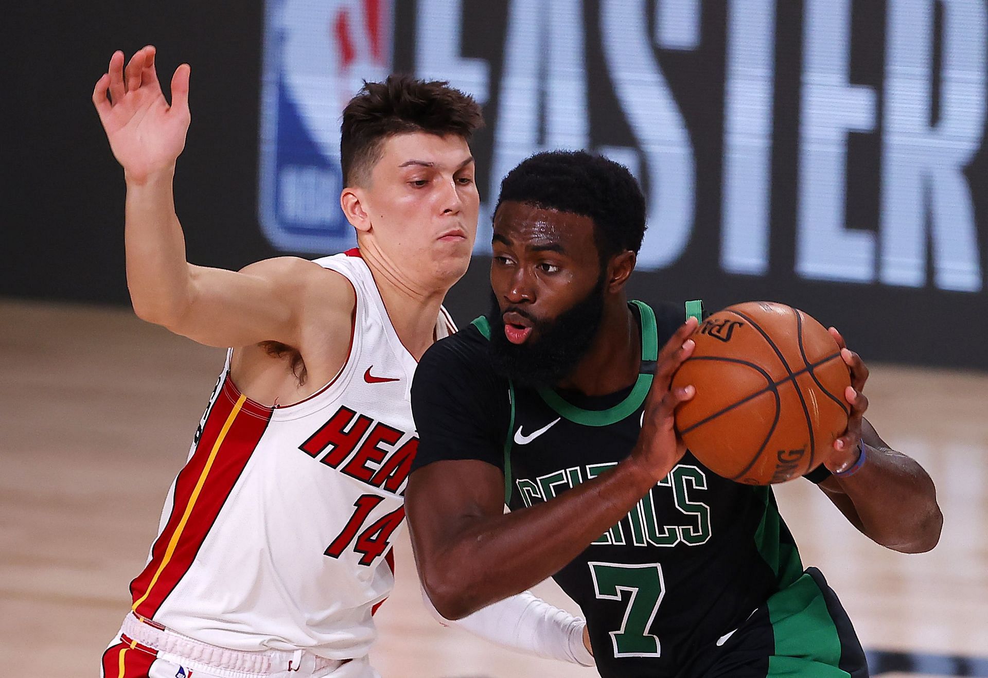 Tyler Herro #14 of the Miami Heat defends Jaylen Brown #7 of the Boston Celtics