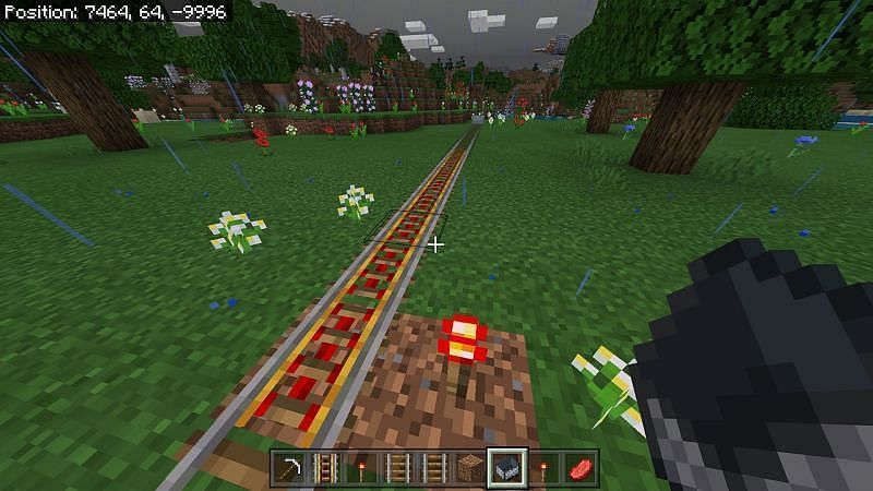 powering any adjacent rails up to nine rails with a torch