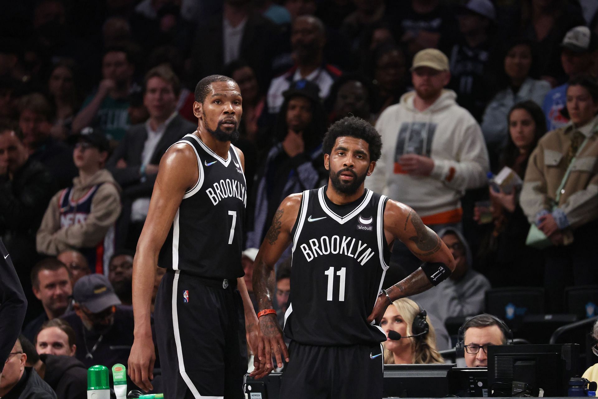 Kyrie Irving discusses the game with Kevin Durant.