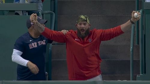 Former Boston Red Sox Johnny Gomes (right) catches Trevor Story's Grand Slam home run in last night's game.