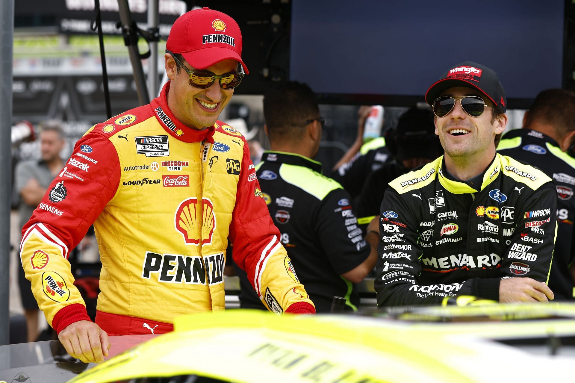 Joey Logano (L) and Ryan Blaney (R) share a laugh in the garage area during practice for the NASCAR Cup Series - All-Star Race at Texas Motor Speedway.