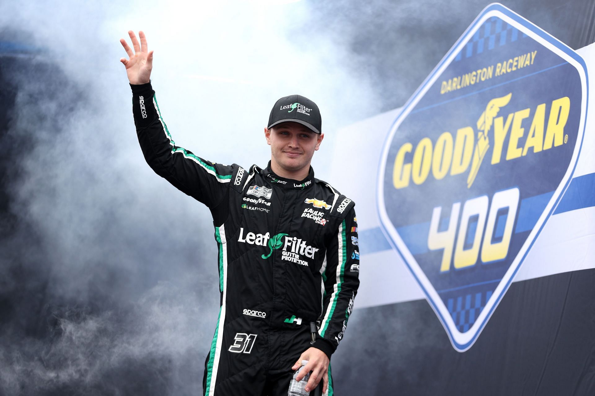 Justin Haley waves to fans as he walks onstage during driver intros before the 2022 NASCAR Cup Series Goodyear 400 at Darlington Raceway in Darlington, South Carolina. (Photo by James Gilbert/Getty Images)